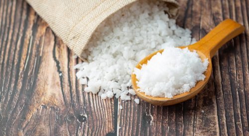 salt in wooden spoon place on floor